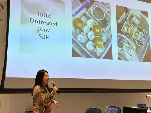 Fei Wu presenting in a lecture hall beside a slide about untreated raw silk and mineral pigments