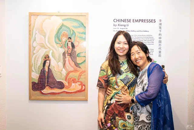 Fei Wu and Xiang Li embracing beside the Chinese Empresses by Xiang Li title wall