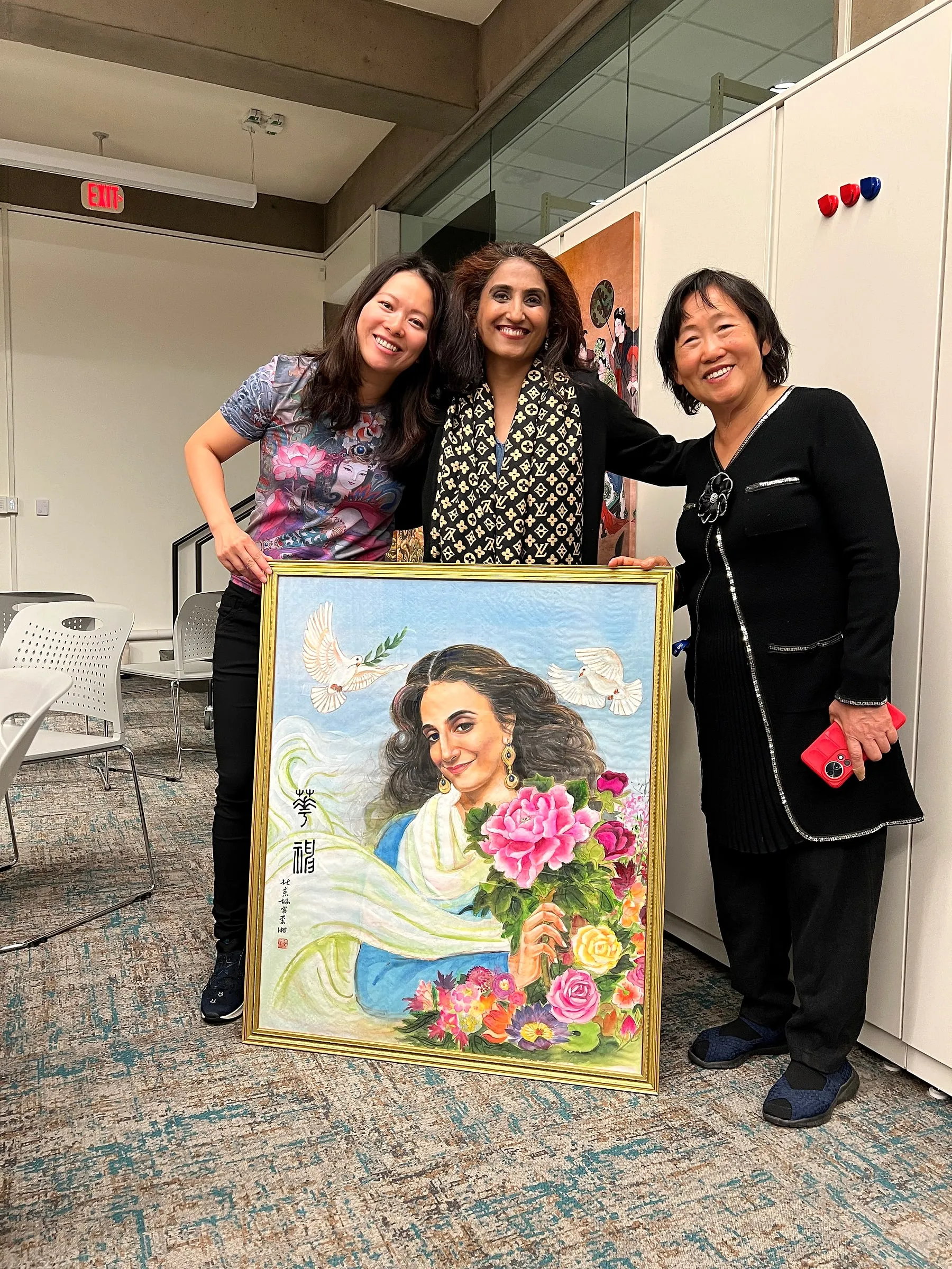 Fei Wu, Tripti Gore Chandorkar and Xiang Li together behind the framed portrait