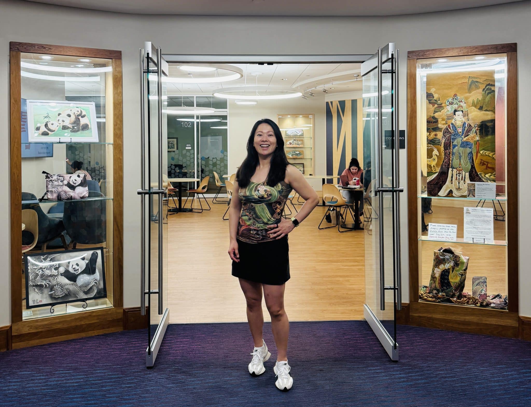 Fei Wu standing in front of the waiting room at the Wellesley Free Library